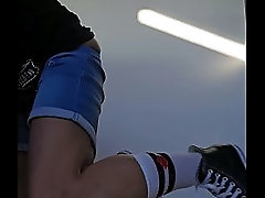 Masturbator in short jeans, white socks and converse sneakers