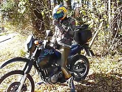 Punkbiker in gold leggings on his Suzuki DR650 Dakar