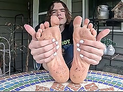 Boy shows off his dirty soles