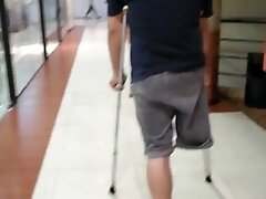 'Amputee guy walking around with crutches'