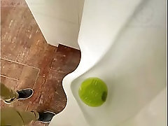 Amateur redhead guy caught pissing in a public toilet'_s urinal - he then quickly plays with his cock before leaving